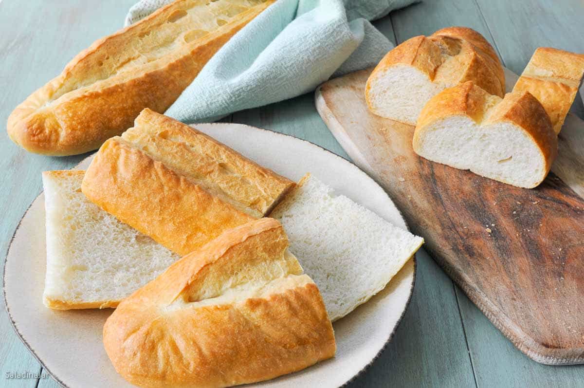 Sliced Pan Cubano or Cuban Bread on a cutting board.