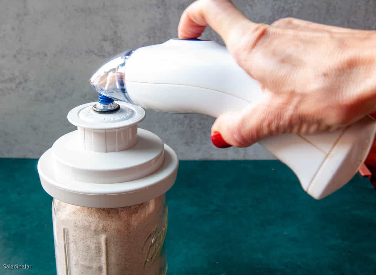 sealing a jar with a handheld sealer.