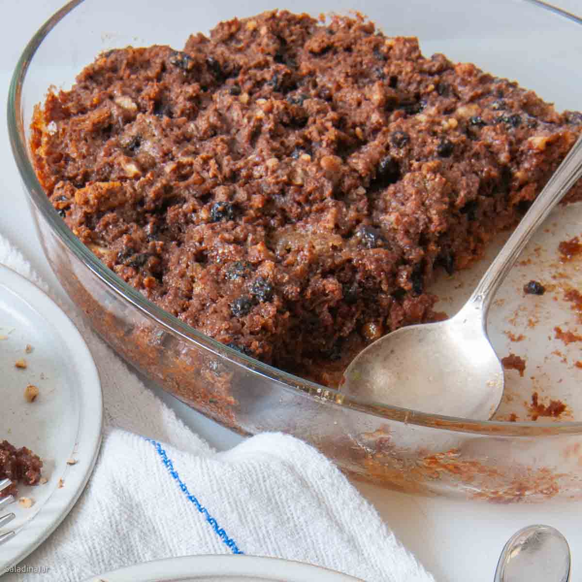 Baked pudding in a dish with a spoon.