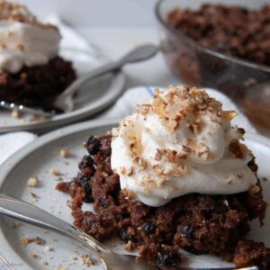 bread crumb pudding on a dish with whipped cream