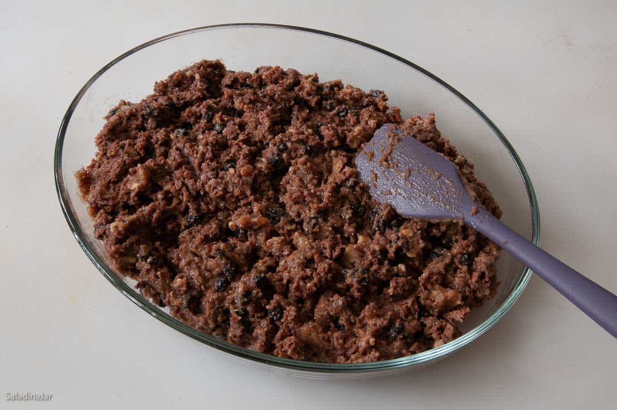 Preparing bread crumb pudding for baking in a casserole dish.