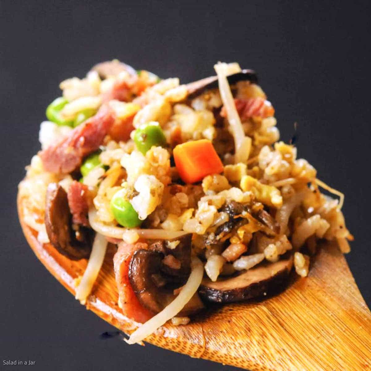Fried rice on a wooden spoon.