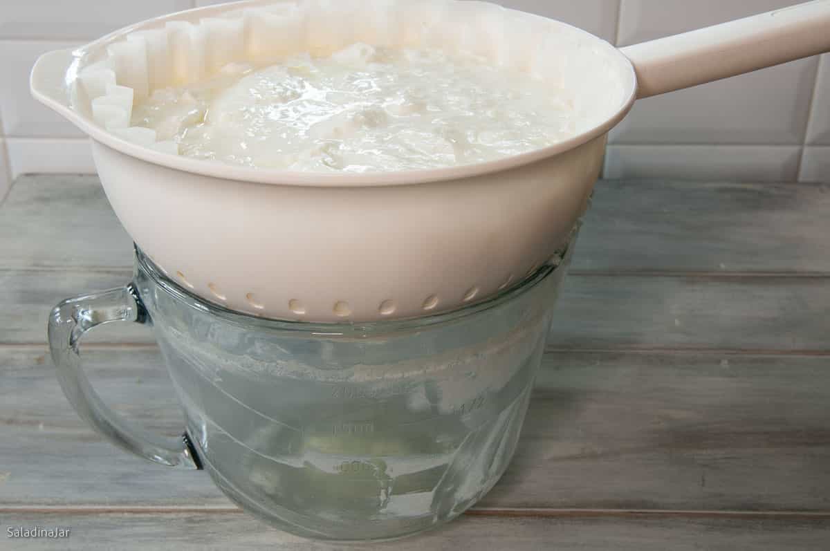 straining yogurt with a cheap strainer and commercial coffee filters.