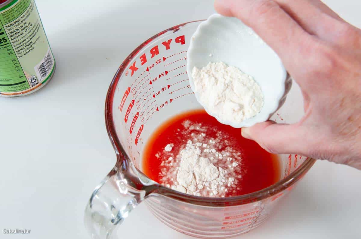adding flour to tomato juice.