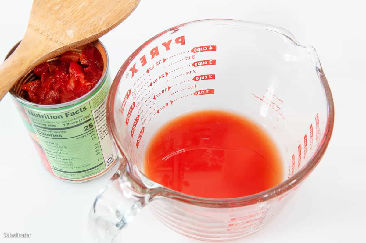 tomato juice in a 1 qt pyrex measuring cup.drained from canned tomatoes
