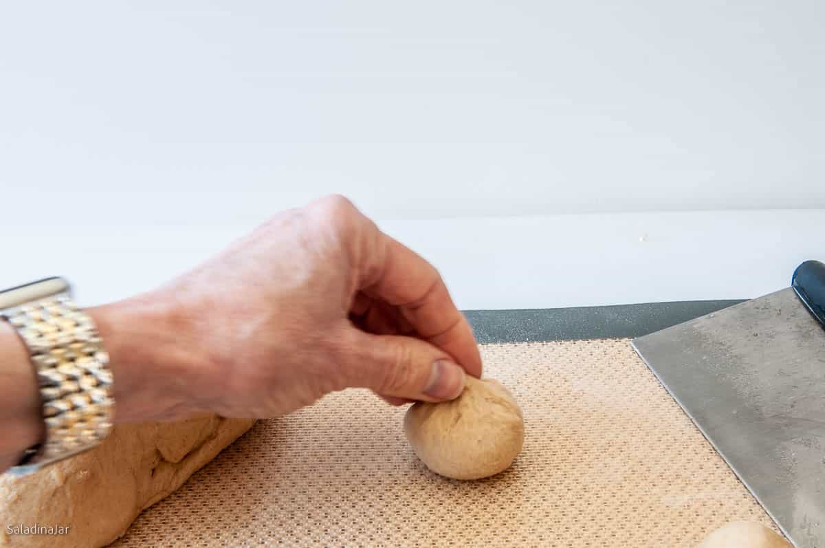 shaping the portions into small dough balls.