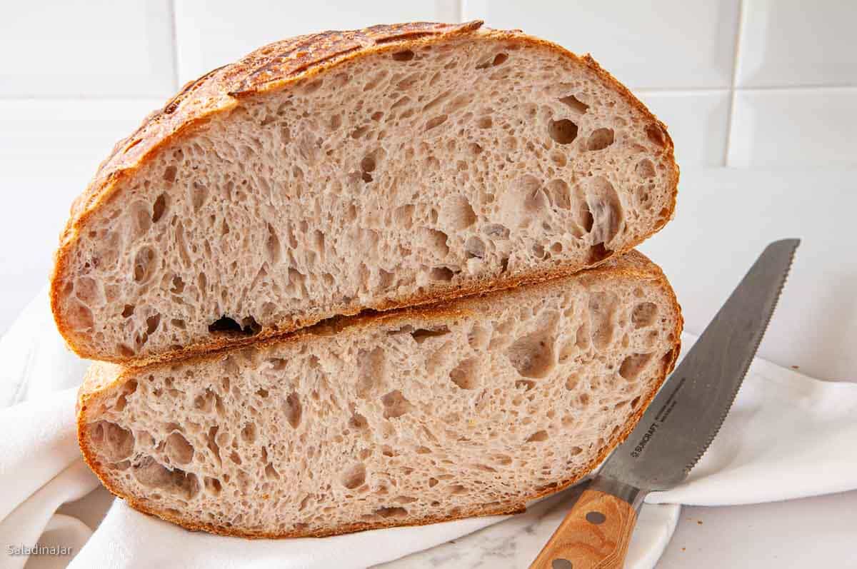 Sliced loaf of dough bread mixed in a bread machine showing th inside texture