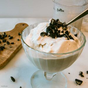 Soft-serve yogurt creami in a bowl with chopped cookies on top