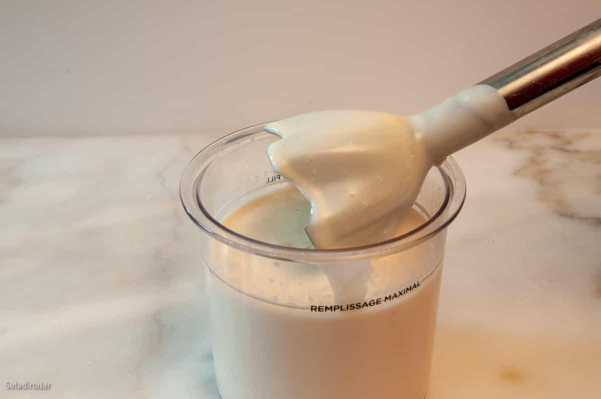Using an immersion blender inside the Creami container.