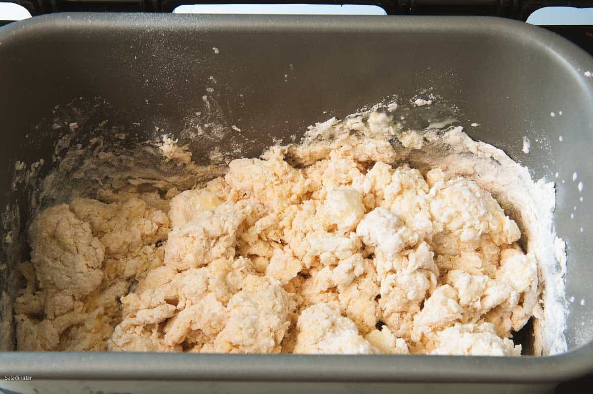 The dough is clumping during the first minute of mixing in the bread machine.