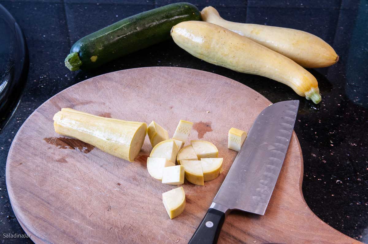 yellow summer squash and zucchini on a chopping board.