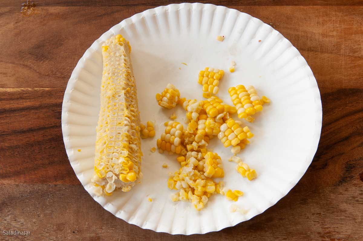 kernals cut from corn on the cob on a paper plate.