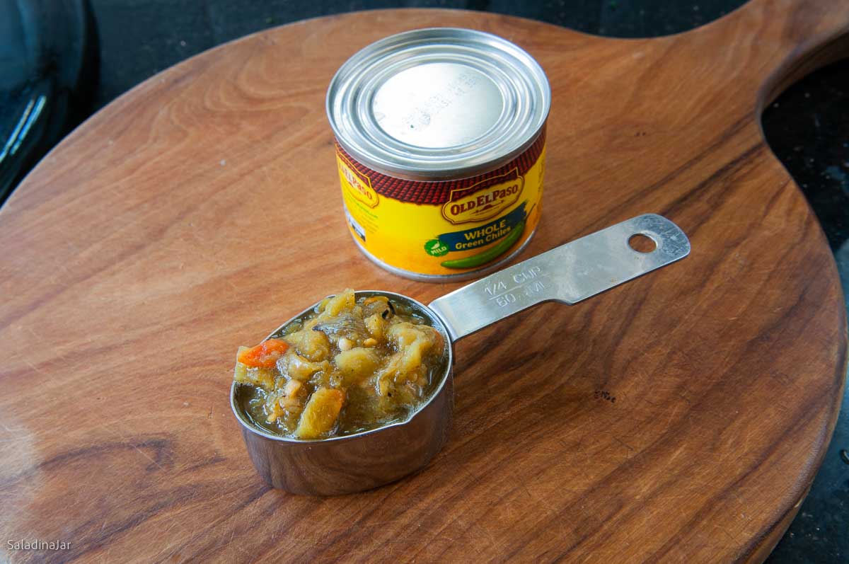 green chiles in a mesuring cup next to the can they came out of.