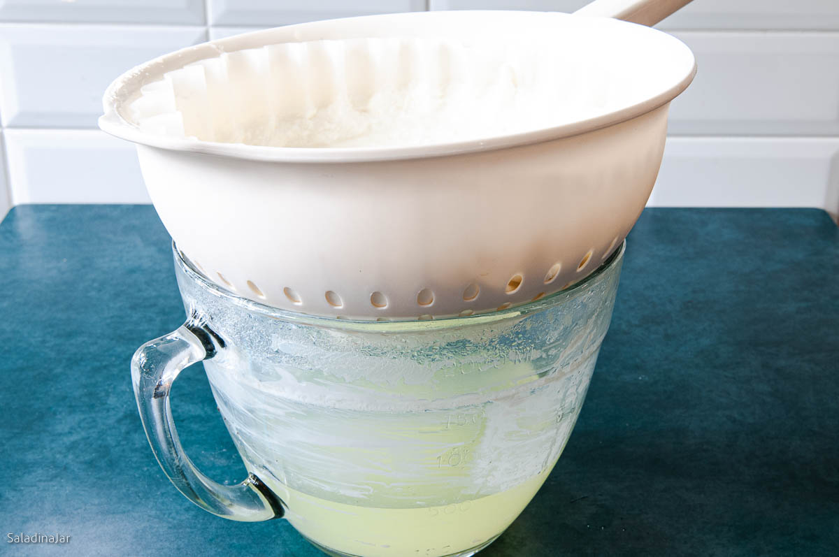 straining whey out of yogurt using a colander and a paper coffee filter.