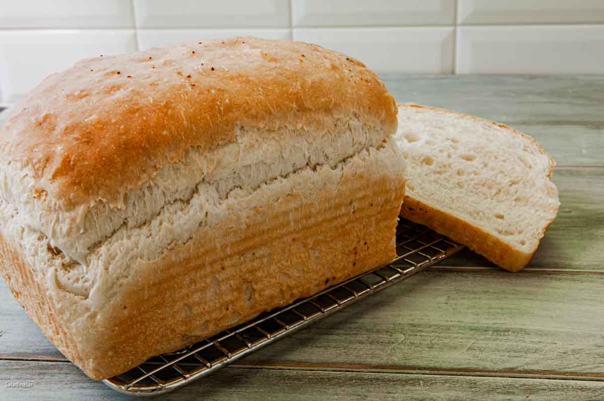 focaccia dough baked in a loaf pan in the oven.