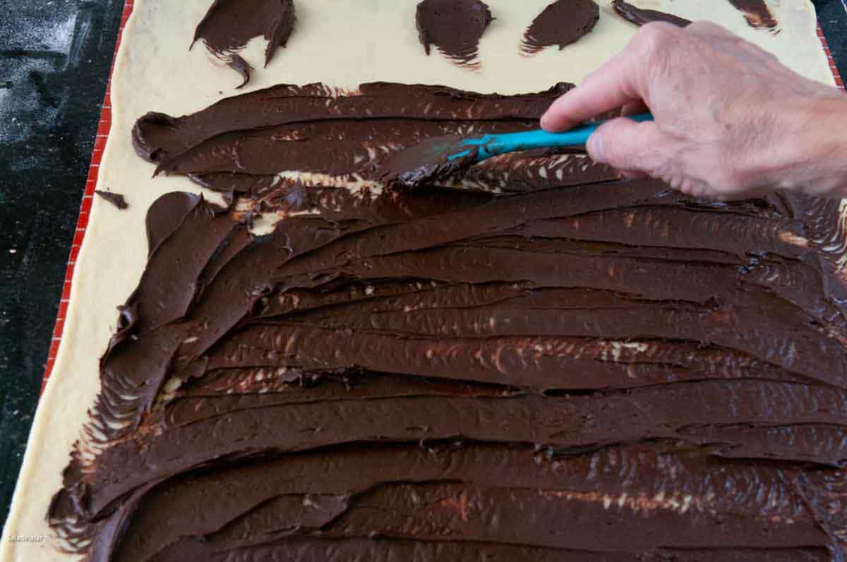 spreading chocolate on the babka.