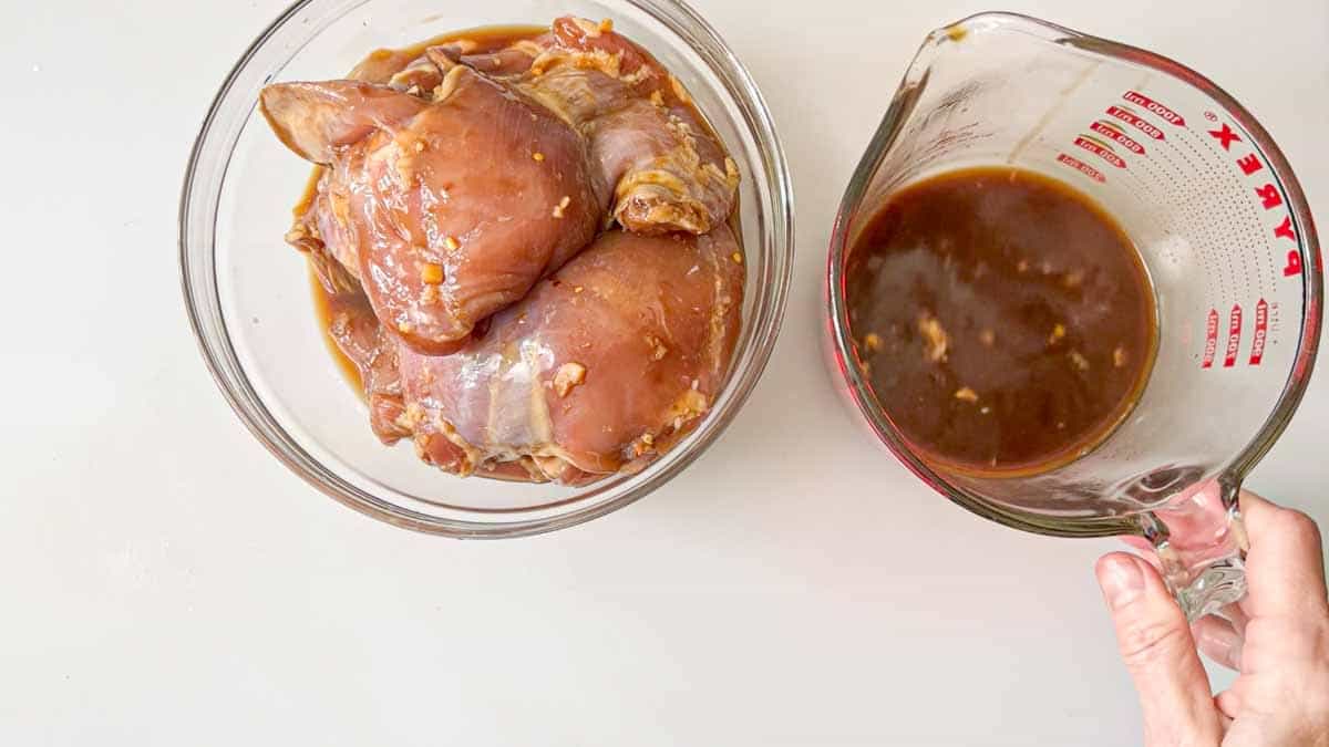 marinade drained from chicken thighs placed in a separate bowl.