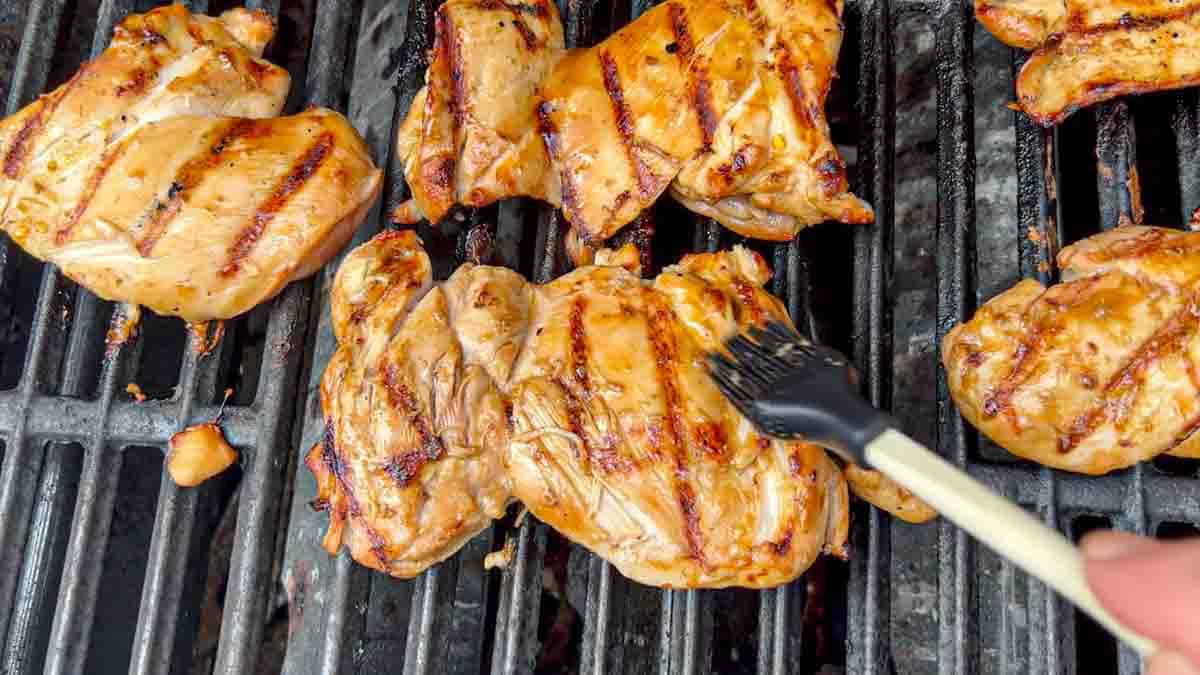 grilled chicken thighs with the smooth side up and bastin them with cooked down marinade.