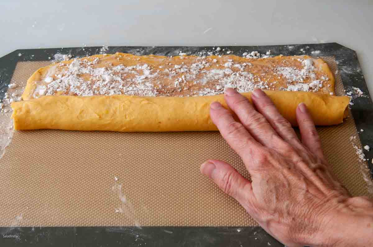 rolling up the dough to make a log.