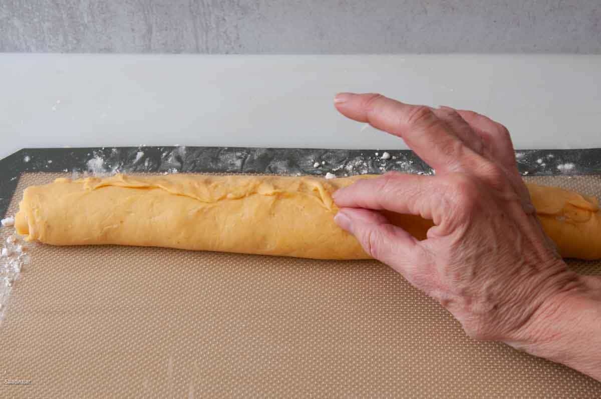 pinching the seams to seal the log.