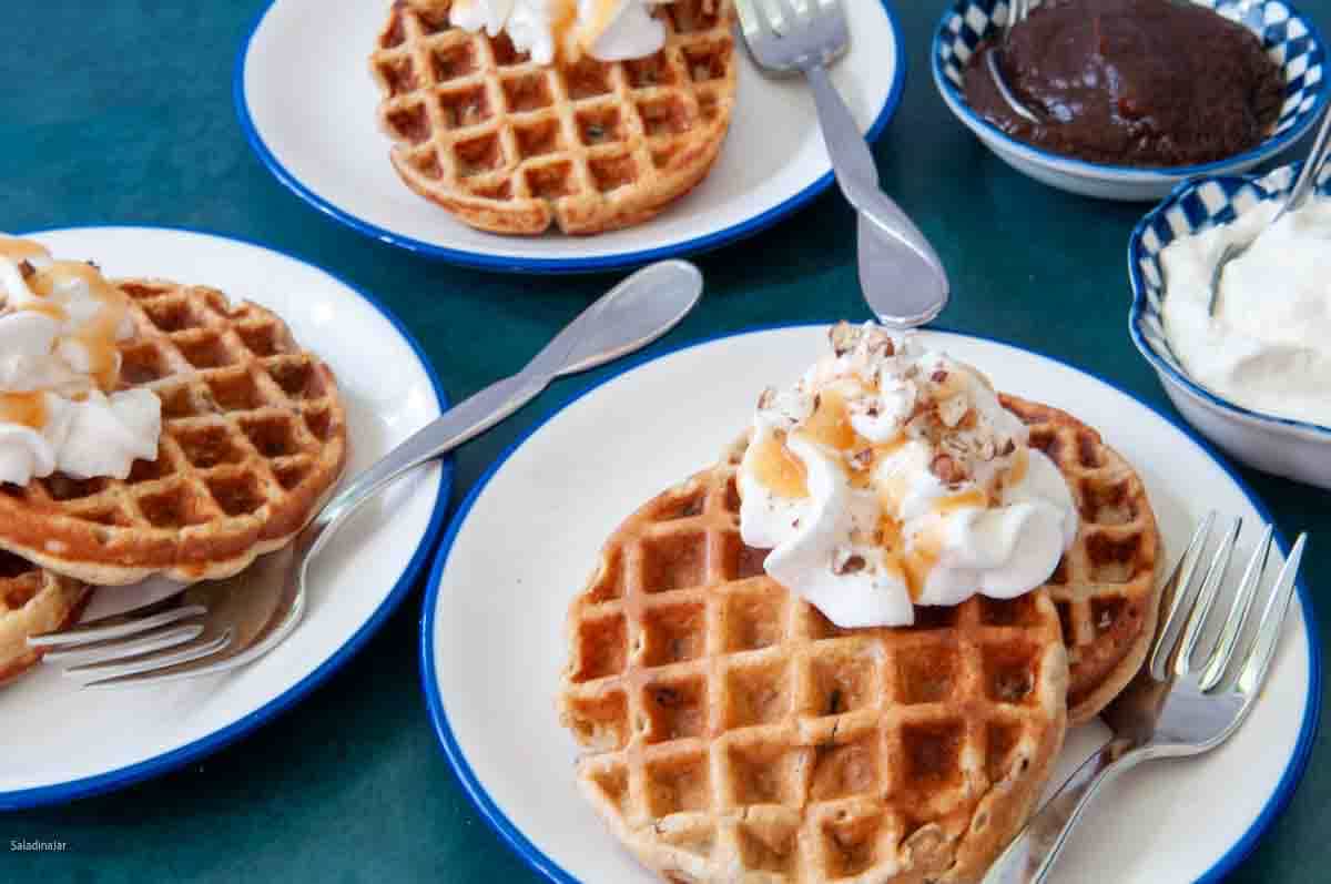 Yogurt Waffles dressed up with whipped cream, caramel syrup and chopped pecans