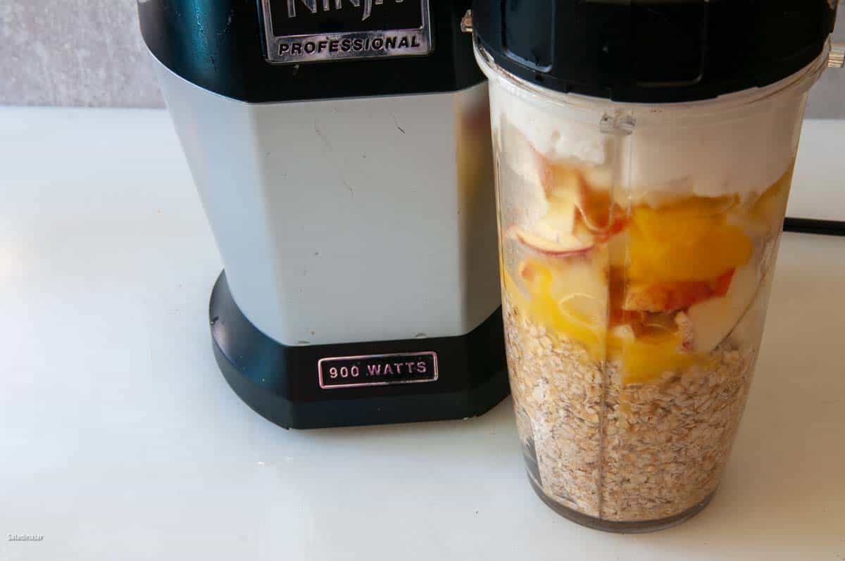 Ingredients layered in a blender with wet ingredients closest to the blade