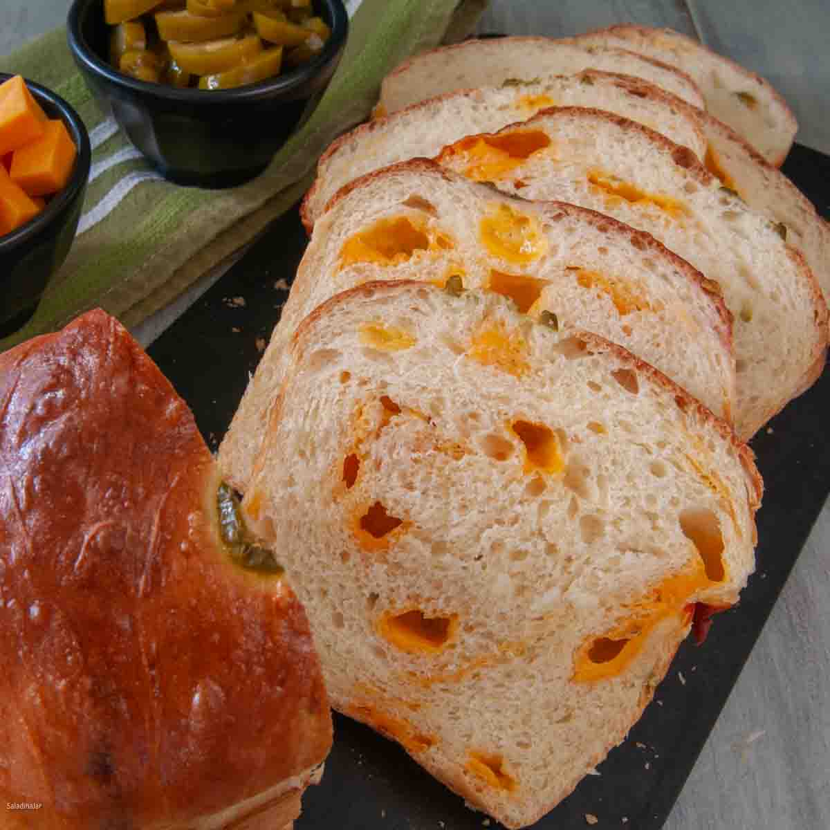 sliced jalapeno-Cheese Bread on a bread board.