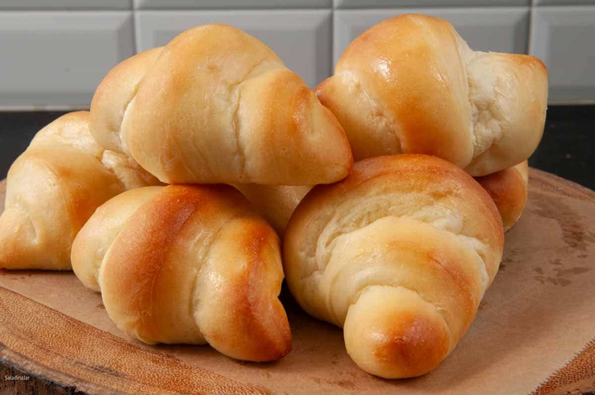Homemade brown and serve rolls on a board--ready to eat