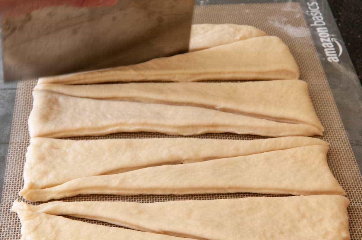 Cutting the dough into slender rectangles.