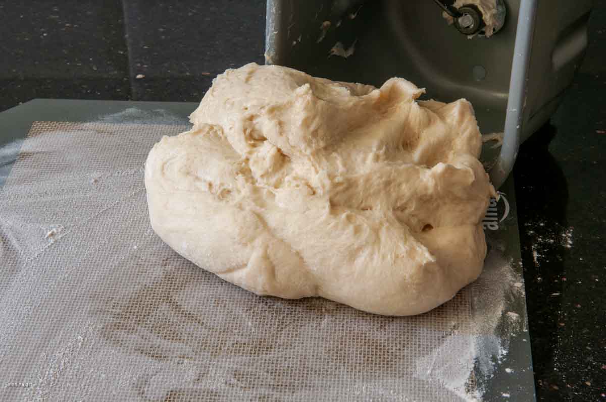 pulling dough out of a bread maker after the DOUGH cycle ends.