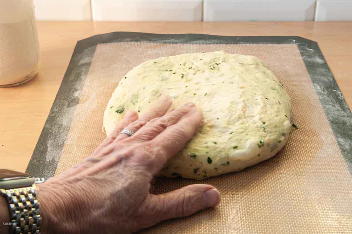 Using hand to lightly compress bubbles, especially around the edges.
