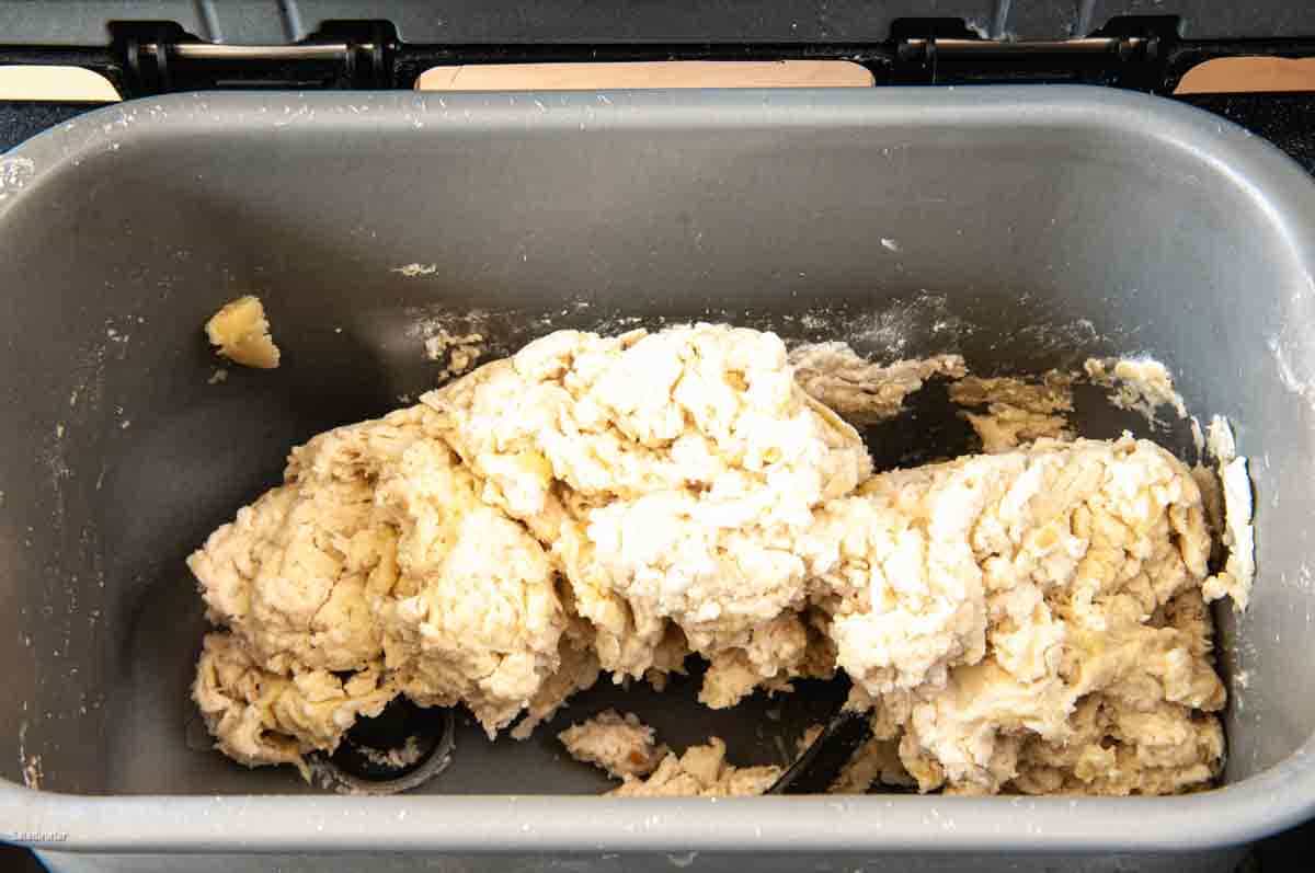 Open the lid and check to ensure the paddles are engaged, and the dough is coming together into a ball or clumping as seen in this image.