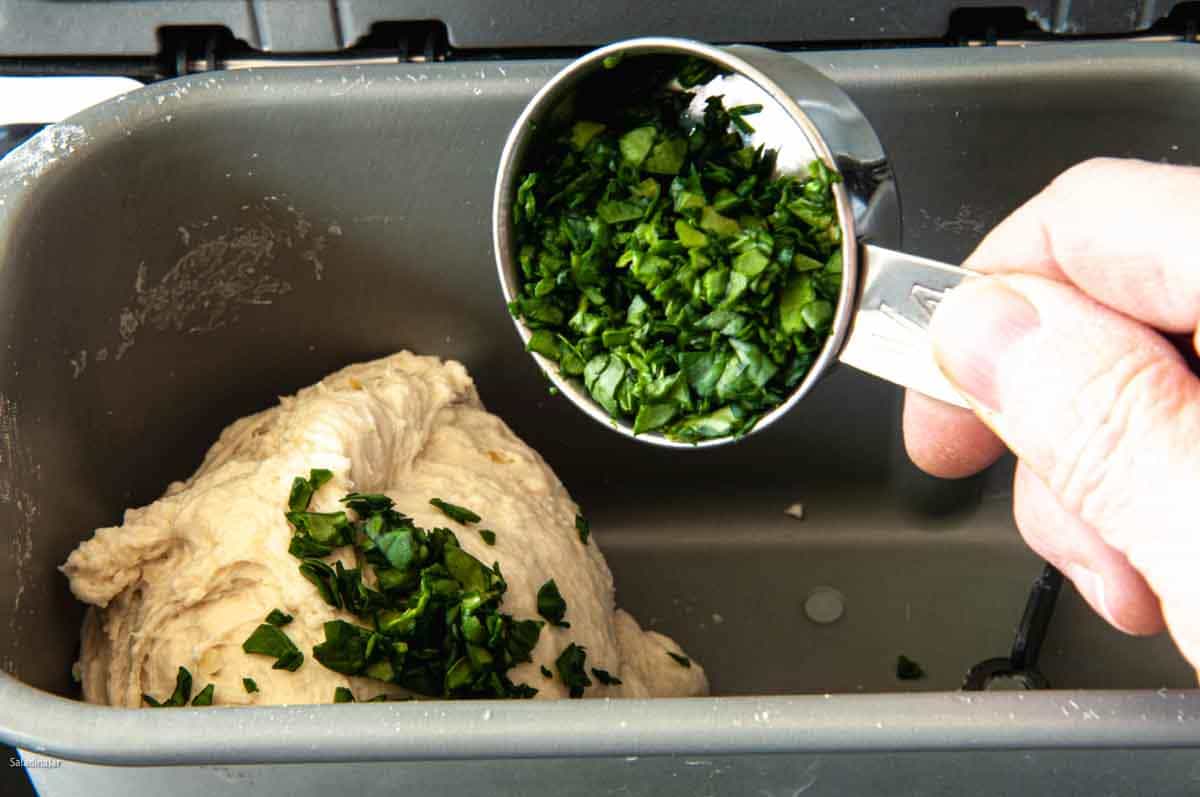 Adding the chopped spinach to the dough in the last minute or two of the kneading phase.