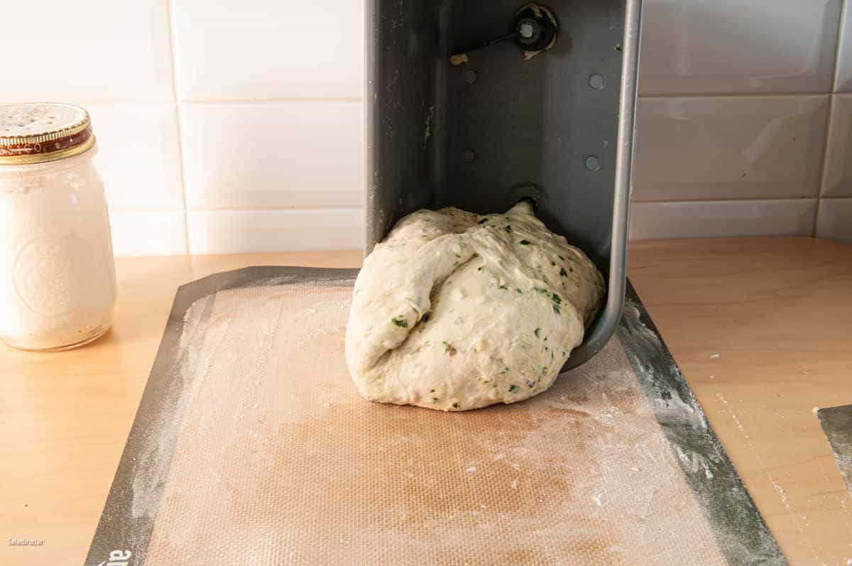 Removing the dough from a bread machine onto a lightly floured surface--in this case a silicone mat.