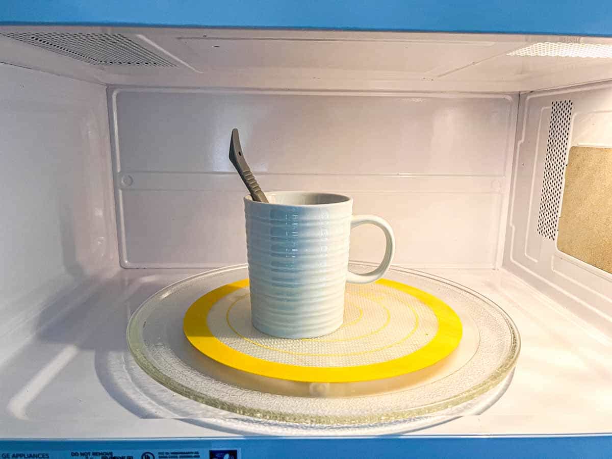 mug full of water in the microwave with a silicone spoon to prevent superheating.