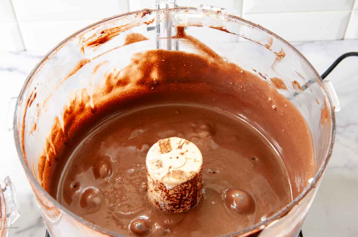 showing chocolate cake batter inside the food processor.