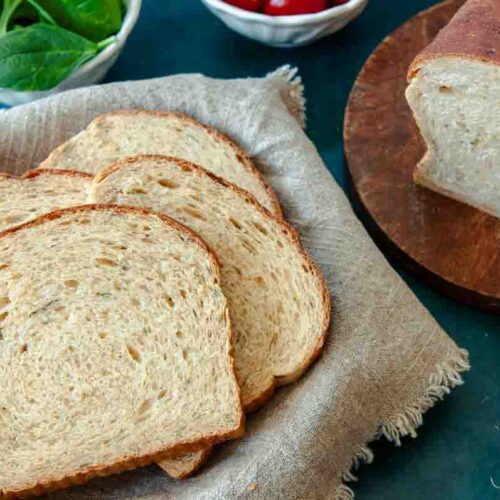 Sliced Spinach Parmesan Bread mixed and kneaded in a bread maker.
