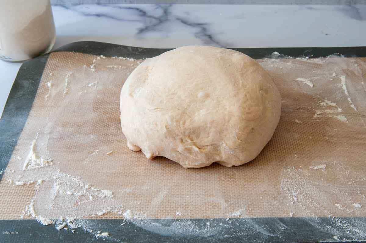 Compressing the dough and shaping into a ball.