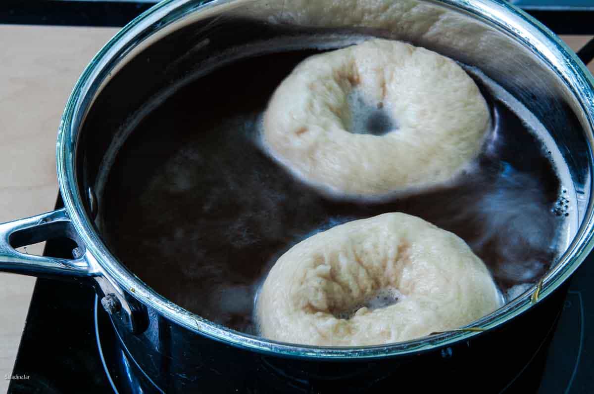 Boiling bagels in water with malted barley syrup.