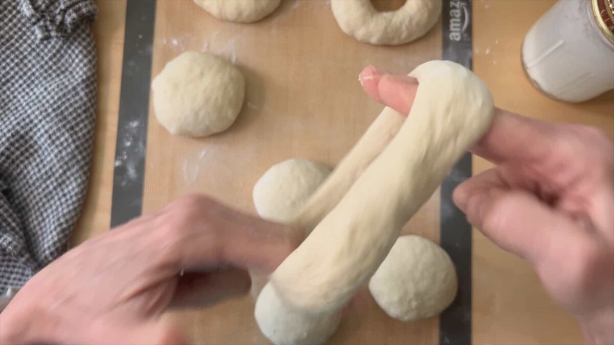 Rotate your hands and fingers inside the bagel hole to stretch it.