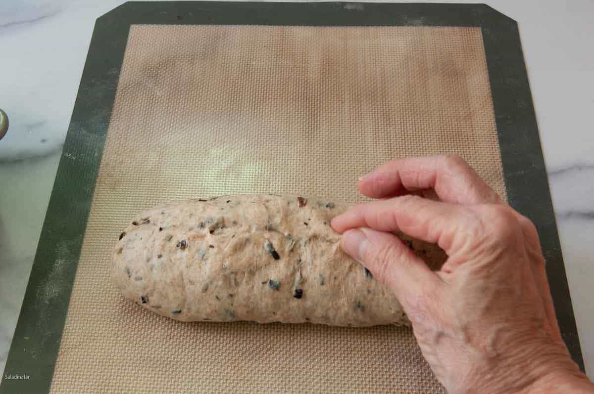 Pinching the seams and ends together.