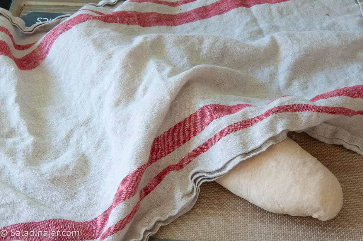 Cover shaped dough for final rise.