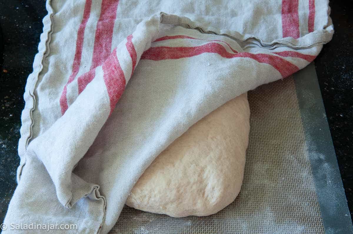 Letting the dough relax under cover before shaping.
