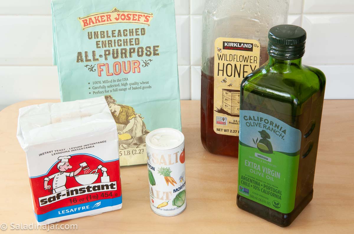 ingredients need to make bread machine pita bread include yeast, flour, honey, olive oil, and salt.