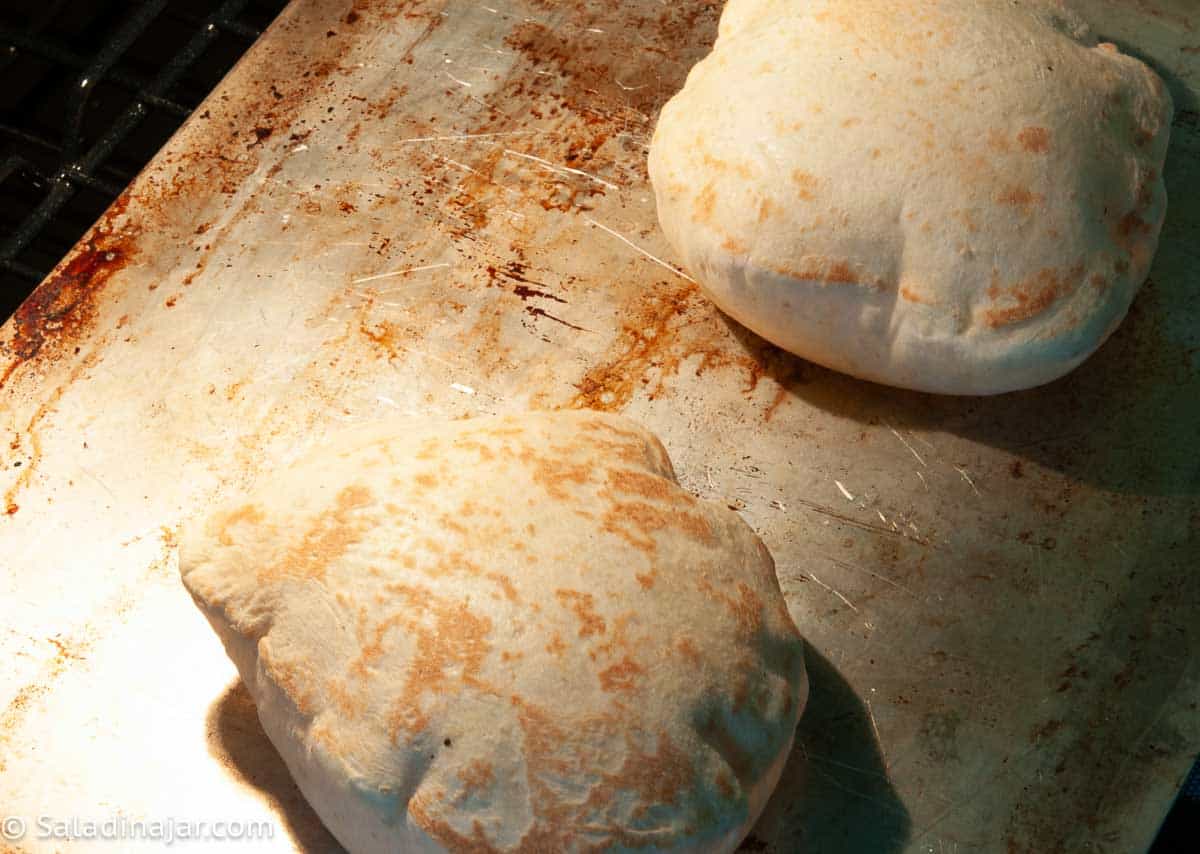 Browned pitas flipped over after puffing.