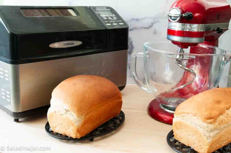 bread machine and stand mixer side by side with loaves of bread made in each
